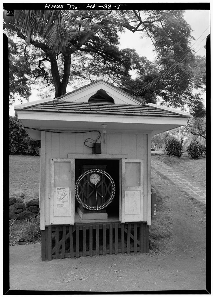 Image description: An ITR time recorder sits within a wooden shed with a tiled porch. End of alt text.